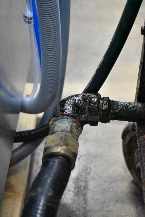 Dean SR42GNS fryer connection lines and fittings. Natural gas-powered, 105,000 BTU. Visible wear on connections.
