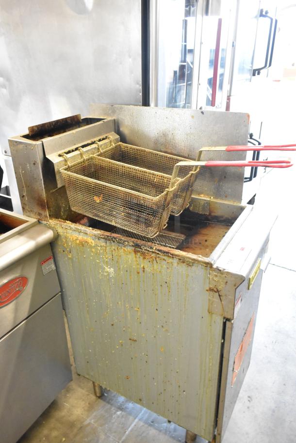2022 Qualite GF-90/NG stainless steel fryer with two metal baskets, side splash guard, 90,000 BTU, shows signs of use.