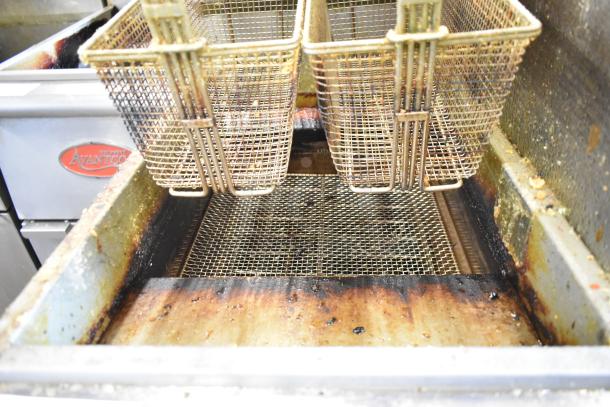 Qualite GF-90/NG stainless steel deep fat fryer with two metal fry baskets and side splash guard, 90,000 BTU, commercial use.
