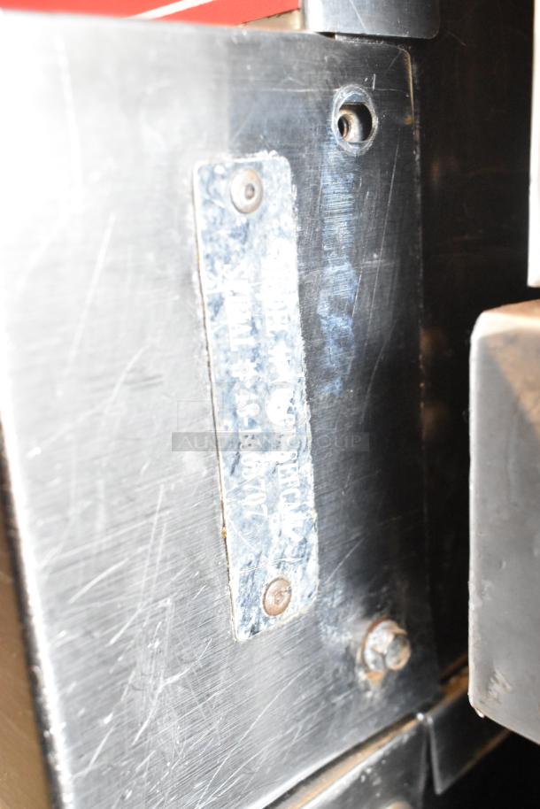 Vulcan VC6GD-SEFCAM oven's metal label with serial and model details, affixed on stainless steel surface.