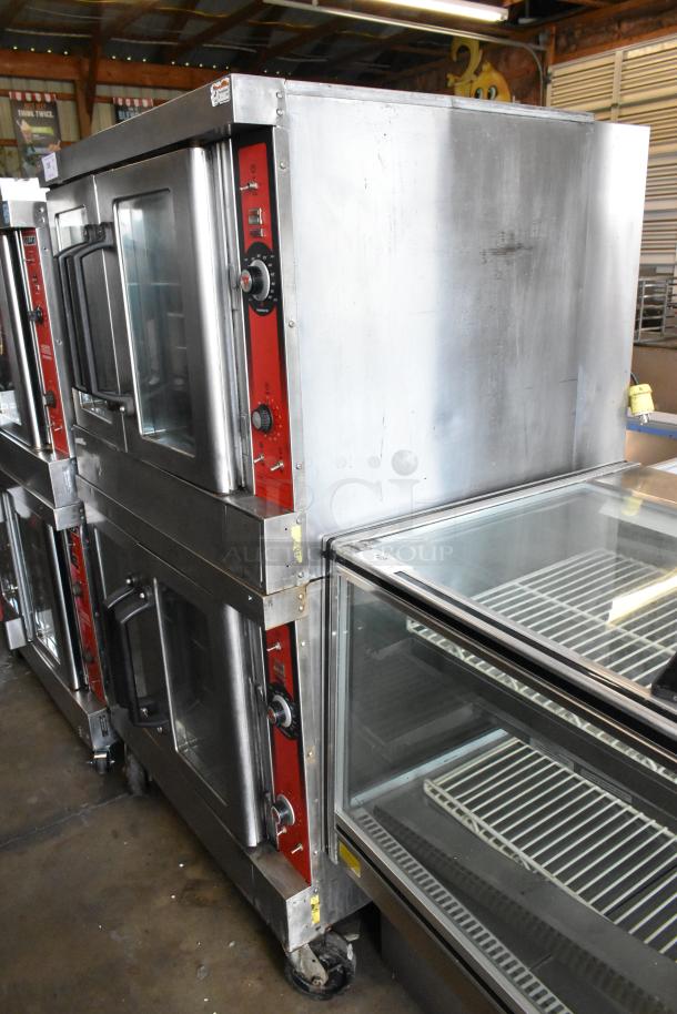 Two Vulcan stainless steel full-size convection ovens with view-through doors, metal racks, and thermostatic controls on casters.