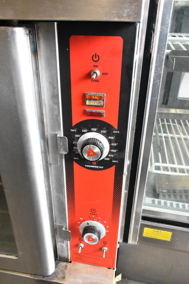 Vulcan stainless steel commercial convection oven with view-through doors, metal racks, thermostatic controls, on casters.
