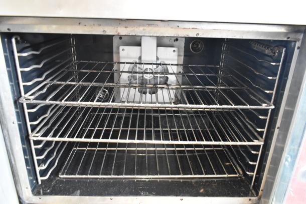 Vulcan stainless steel convection oven, full-size, view-through doors, metal racks, thermostatic controls, commercial casters.