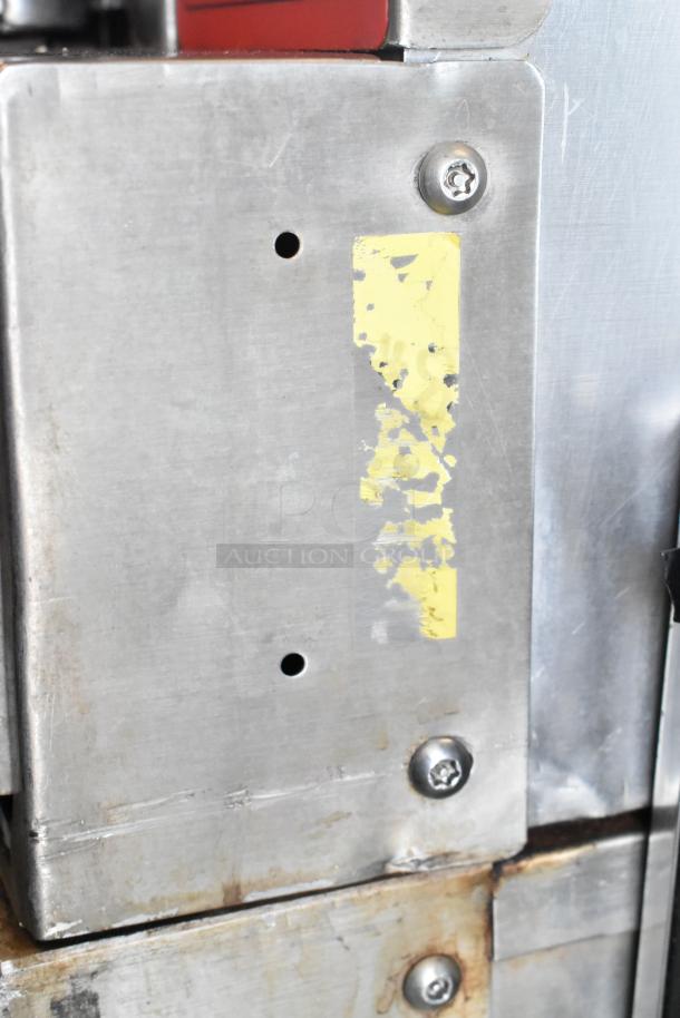 Vulcan stainless steel convection oven section with visible screws and faded yellow label, part of commercial unit.