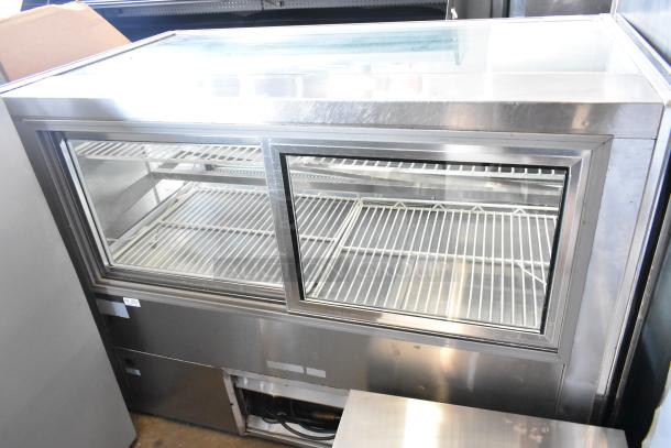 Stainless steel deli display case merchandiser, floor style, 115 volts, 1 phase, clear glass doors, shelves visible, commercial use.