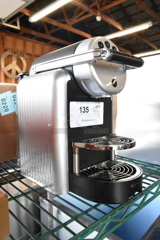 BRAND NEW Nespresso Zenius espresso machine, 120V, single-serve capsule, minor scratches, auction tag visible.