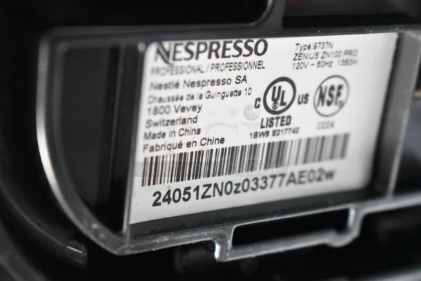 Barcode and label on Nespresso Zenius capsule espresso machine, showing model ZN100 PRO, 120V, made in China. UL and NSF listed.