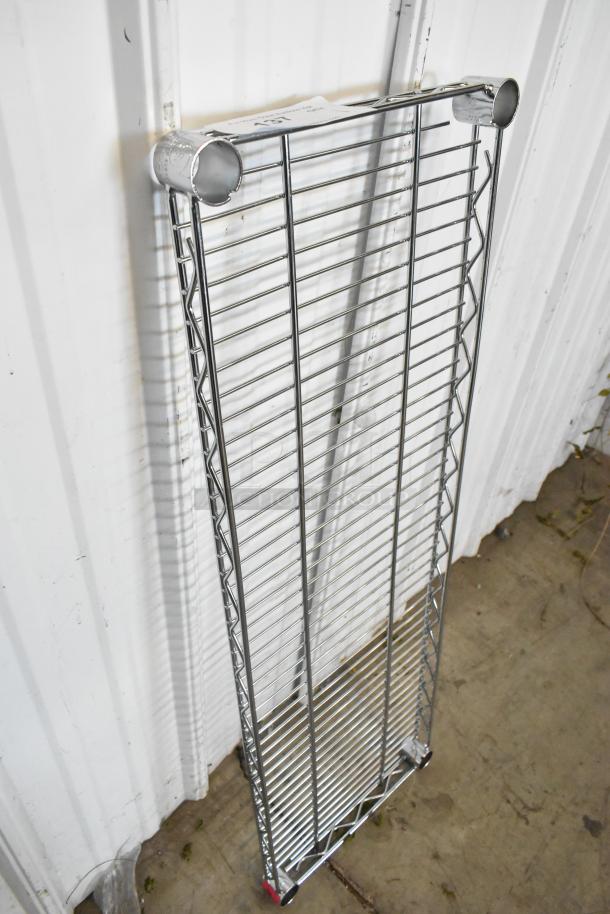 Chrome finish wire shelf, new condition. Features durable metal rods and cylindrical connectors, ideal for storage solutions.