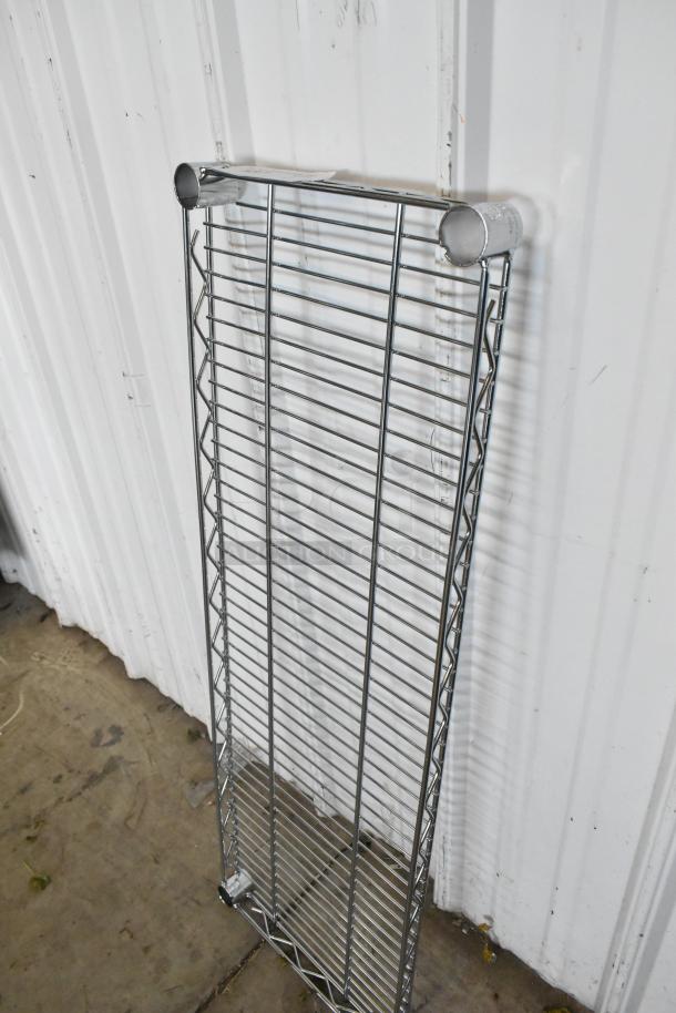 Chrome finish wire shelf, durable design, excellent condition. Ideal for storage, featuring cylindrical supports.
