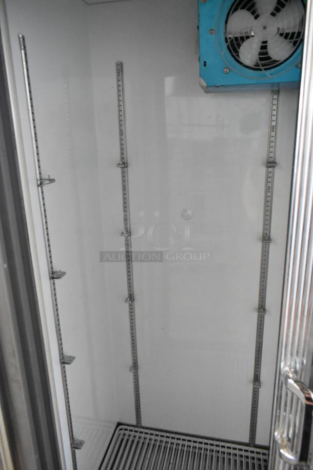 Universal Coolers commercial 2-door reach-in cooler, metal construction, adjustable shelving, 115 volts, 1 phase.