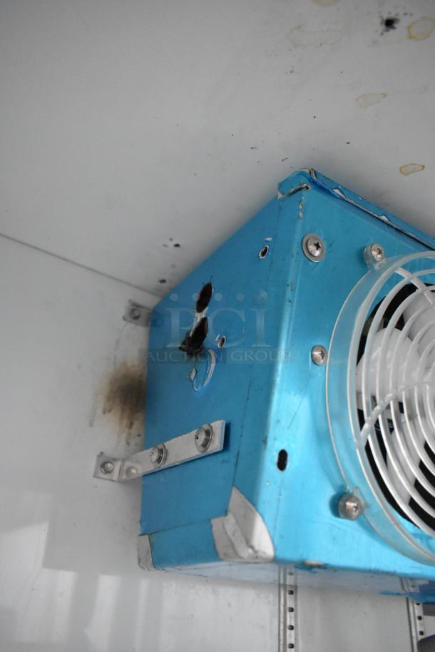 Universal Coolers 2 Door Reach In Cooler Merchandiser, blue metal with visible wear, mounted fan, 115 volts, 1 phase.