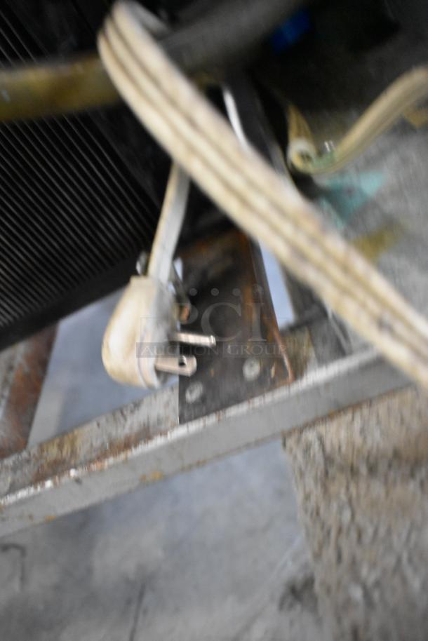 Power plug of Universal Coolers 2 Door Reach In Cooler, shown on a metal frame, indicating electrical connection.