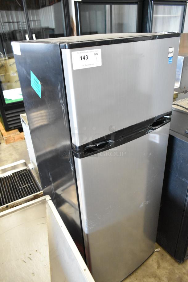 Avanti chrome finish cooler with freezer, 115 volts, 1 phase. Minor surface scratches, auction tag visible on front.