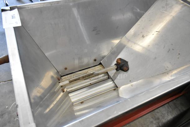 Metal commercial countertop cookie dough depositor, stainless steel, used condition, auction tag visible.