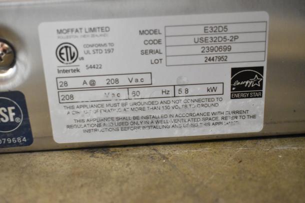 Label on Moffat E32D5 convection oven, detailing model, serial number 2390699, 208V, 5.8 kW, Energy Star certified. Door latch faulty.