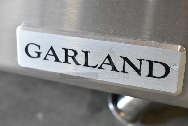 Brand new Garland stainless steel gas griddle, scratch and dent, commercial countertop model, durable for kitchen use.