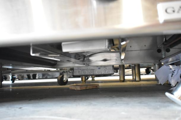 Garland stainless steel gas-powered griddle, scratch and dent condition, commercial countertop model, visible caster wheels.