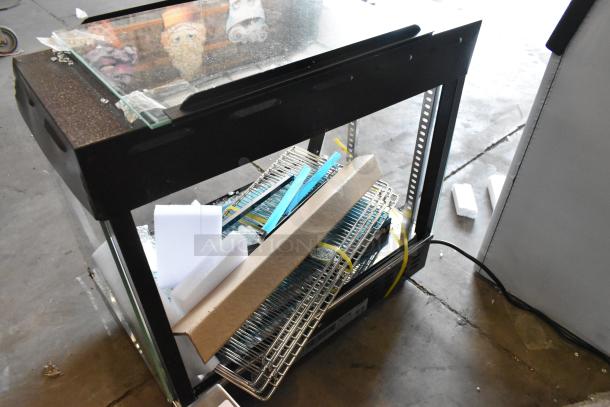 Brand new Avantco 177HDC26 heated display case, 26", with broken glass. Features 3 shelves, sliding doors, 120V, 1 phase.