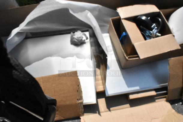 Brand new 2025 True TSSU-72-30MB-ST-HC stainless steel sandwich salad prep table in box, shows packaging and components.