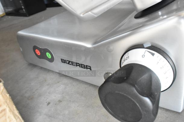 Brand new 2025 Bizerba GSE 12 commercial slicer; metal body, 12" manual gravity feed, 110V, 1 phase, with control knobs.