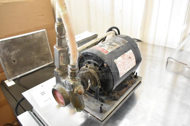 Cornelius Intelli Pump Motor, 115 Volts, 1 Phase. Used condition with visible labels and attached piping.
