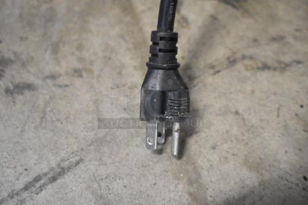 "Black power plug connected to the Cornelius Intelli Pump Motor, 115 volts, 1 phase."