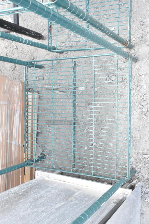 Green two-tier wire shelving unit with sturdy metal frame. Requires dismantling for transport. Consider freight costs.