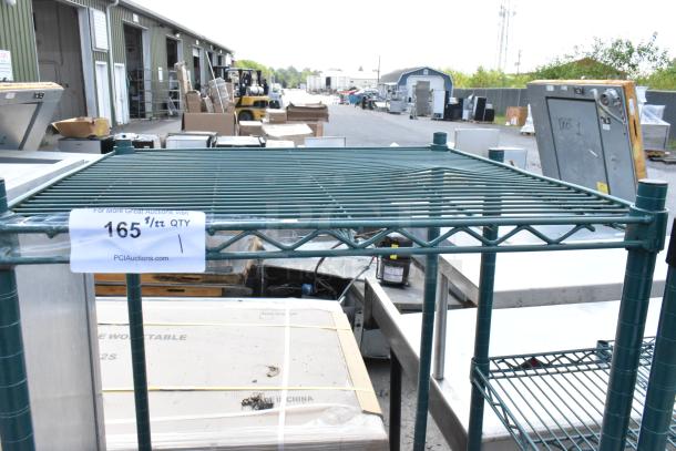 Green finish 2-tier wire shelving unit, industrial setting, buyer dismantles, visible label indicates auction details.