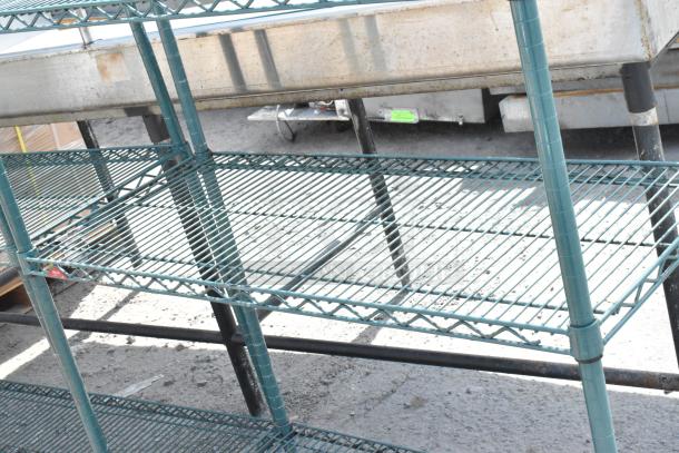 Green 4-tier wire shelving unit, metal frame, sturdy design, buy must dismantle, additional freight charges may apply.