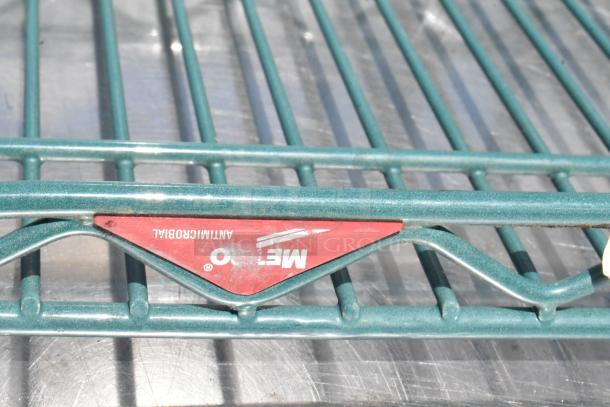 Metro green wire shelf with antimicrobial coating and visible brand marking. Durable construction and excellent condition.