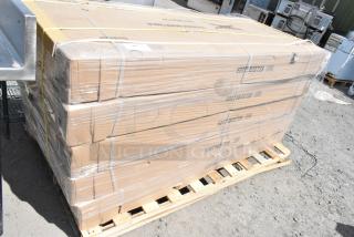 Stack of 5 boxes containing new Regency 600TSB3072S stainless steel work tables with 4" backsplash, on a pallet, wrapped in plastic.