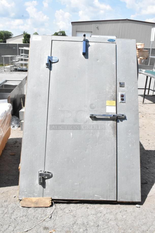 Norlake self-contained walk-in freezer box with Tecumseh compressor and Norlake condenser, gray exterior, sturdy latches.