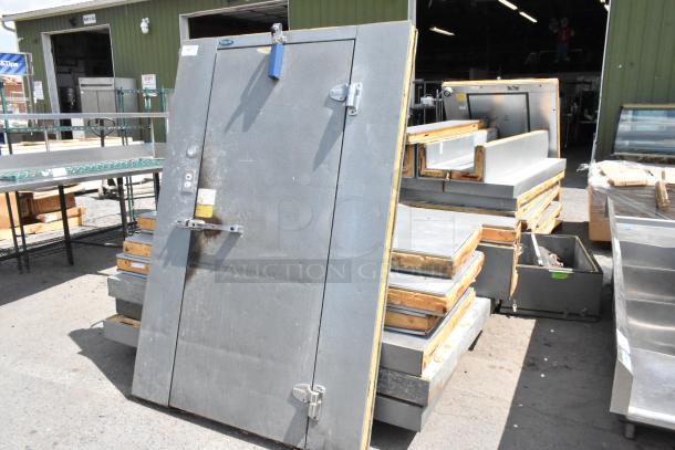 Norlake self-contained walk-in cooler box with compressor and condenser, gray finish, in used condition, some visible rust.