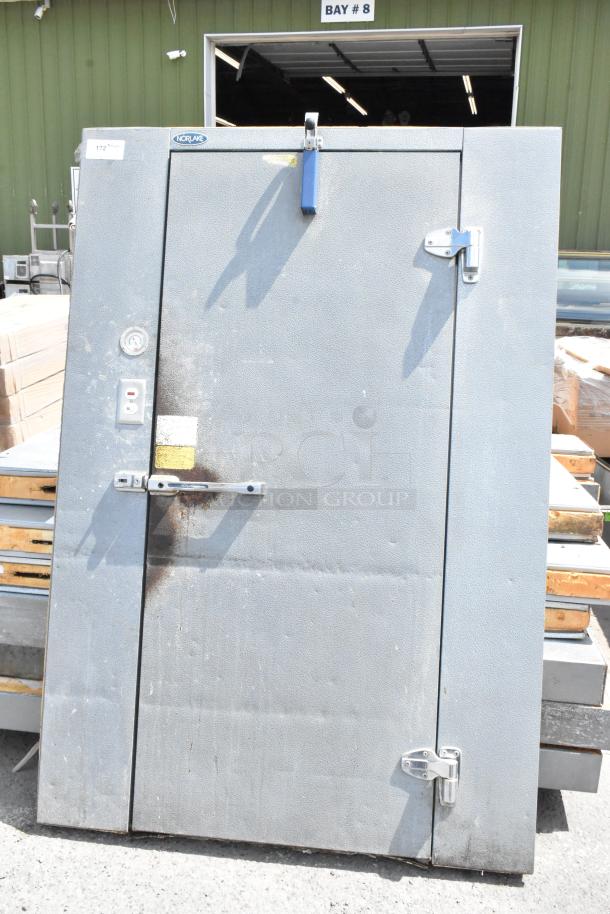 Norlake self-contained walk-in cooler box with compressor and condenser. Features steel door, visible Norlake logo.