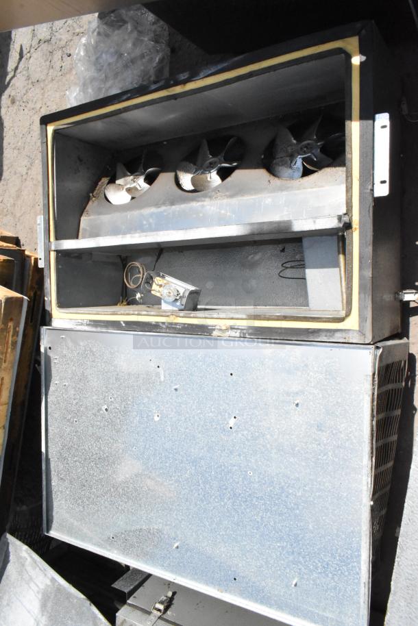 Norlake self-contained walk-in cooler box with compressor and condenser. Visible wear. Includes industrial fans and controls.