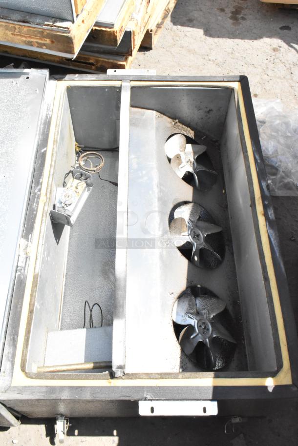 Norlake self-contained walk-in cooler box with compressor and Norlake condenser, showing interior fans and components.