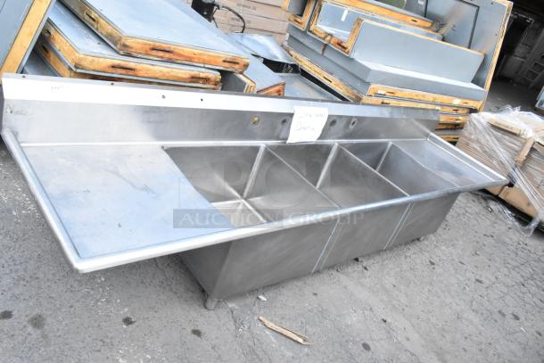Yukon Stainless Steel 3 Bay Sink with dual drain boards. No legs. Used condition. Tags indicate defects.