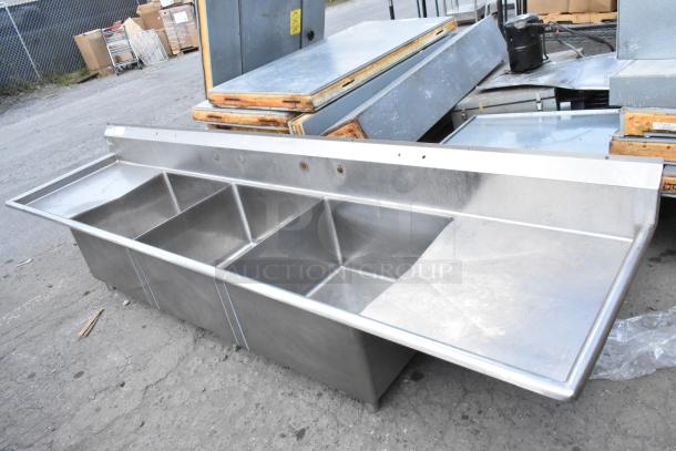 Yukon Stainless Steel 3 Bay Sink with dual drain boards, no legs, in used condition.