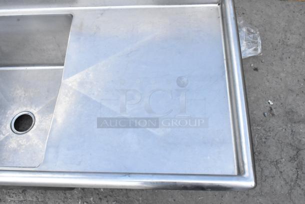 Yukon stainless steel 3 bay sink with dual drain boards, no legs. Clean, durable workspace, ideal for commercial settings.