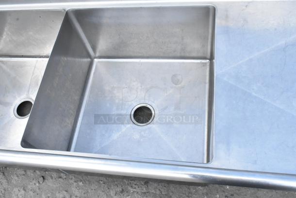 Yukon stainless steel 3 bay sink with dual drain boards, no legs, features three compartments, visible drains, and polished finish.