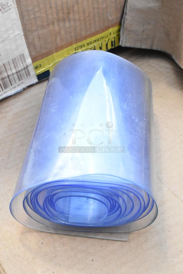 Brand new scratch and dent plastic strip curtain roll, clear PVC, tightly coiled, minor imperfections visible.