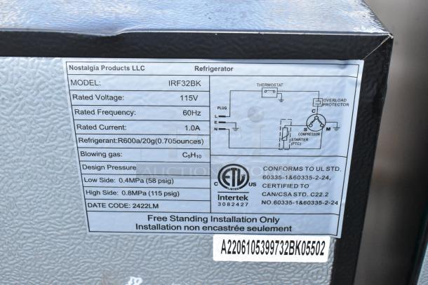 4 mini coolers including Whirlpool WH31S1E, Galanz GLR31TS1E02, Nostalgia IRF32BK, Magic Chef HMAR45HCSE. Factory tag reads Nostalgia IRF32BK with specs.