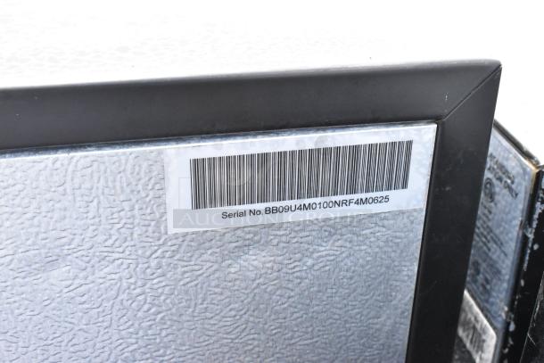 Close-up of a mini cooler corner with a serial number label. Condition is not clearly visible.