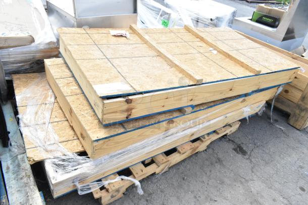 Brand new items in crates, including Hussmann 3201478BX glass door, ready for auction. Three items available, mint condition.