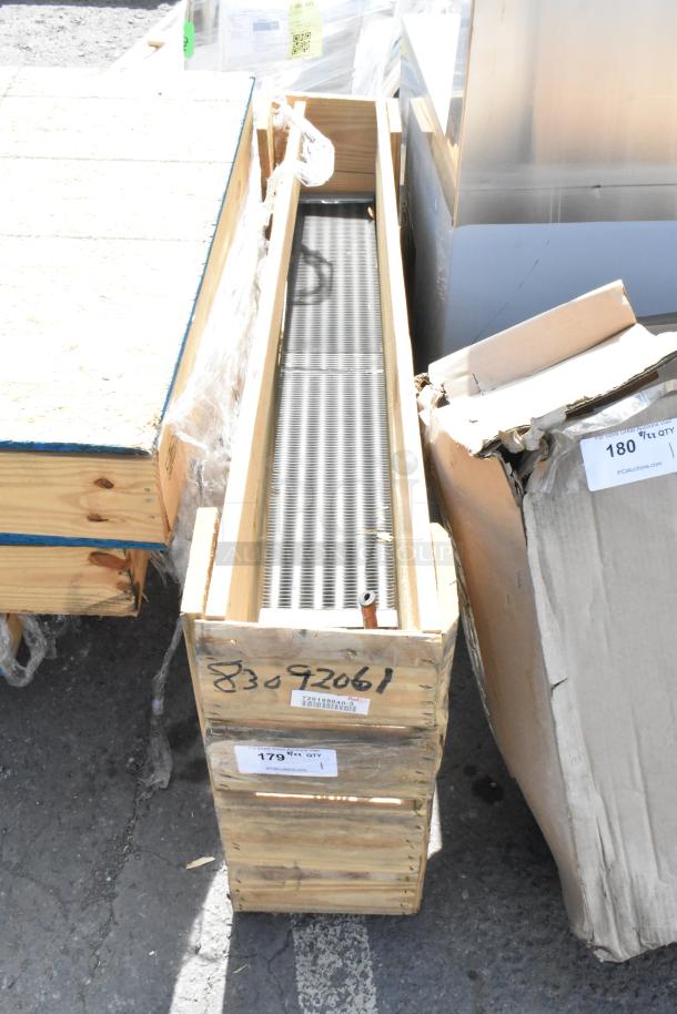 Brand new evaporator coil in a wooden crate, labels showing model number 83092061, excellent condition.