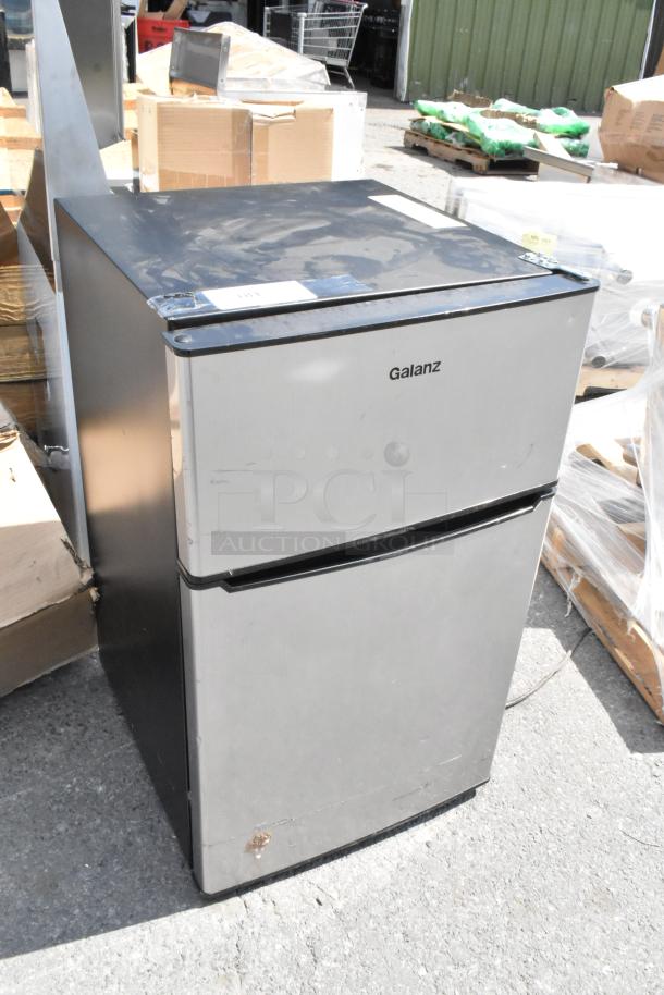 Galanz GLR31TS1E02 mini cooler with freezer, 115 volts, 1 phase. Slightly scratched exterior, functioning condition.