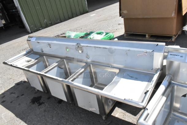 BRAND NEW SCRATCH AND DENT Regency 600S31515215 3-bay stainless steel sink, dual drain boards, visible dents, NSF tag.