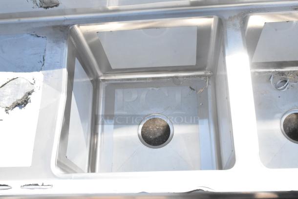 Regency 600S31515215 stainless steel 3 bay sink with dual drain boards; new with scratch and dent marks.