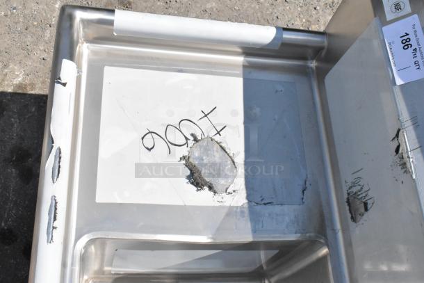 Brand new Regency 600S31515215 stainless steel 3-bay sink with dual drain boards, scratch and dent, visible damage on corner.