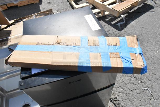 Cardboard box labeled "Galvanized" on concrete, likely packaging for Regency 600S31717 commercial sink.